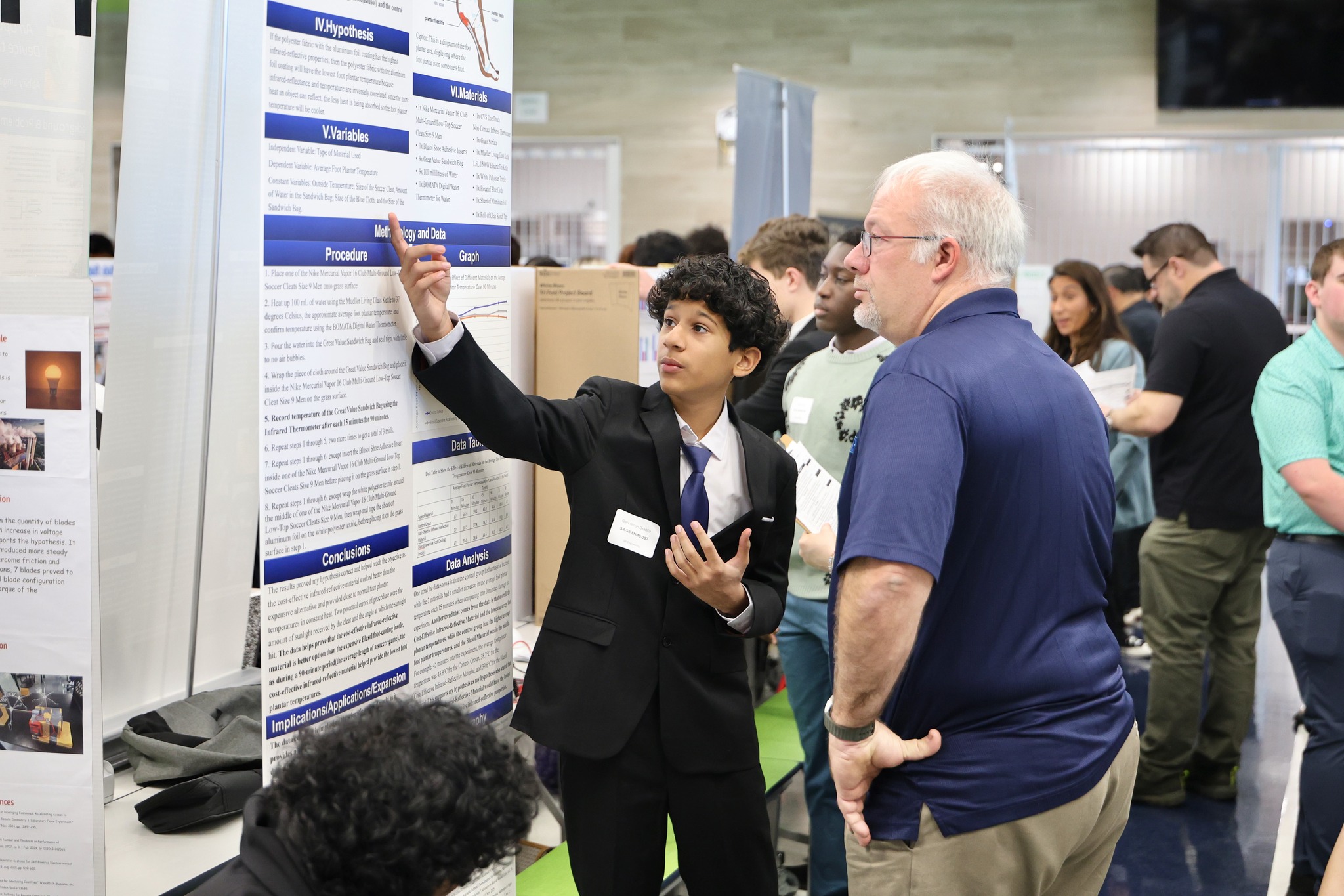 student explaining project - <p>Congratulations to all of our students who participated and thank you to the organizers and judges!</p>